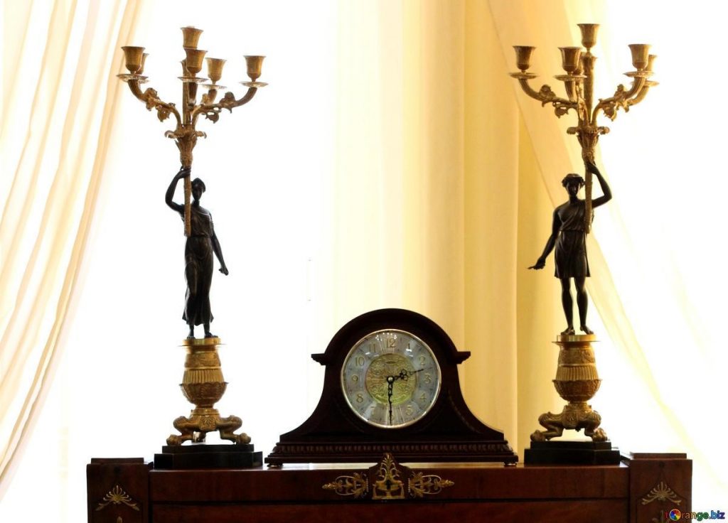clock, candle stands  on the fire place mantle