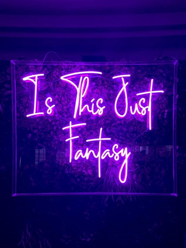 A-purple-neon-sign-that-reads-“Is-this-just-fantasy