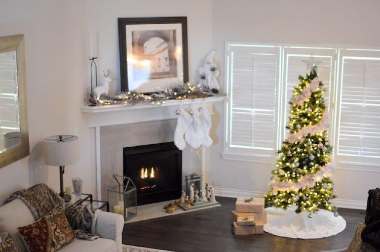 A room with a fireplace and a Christmas tree.